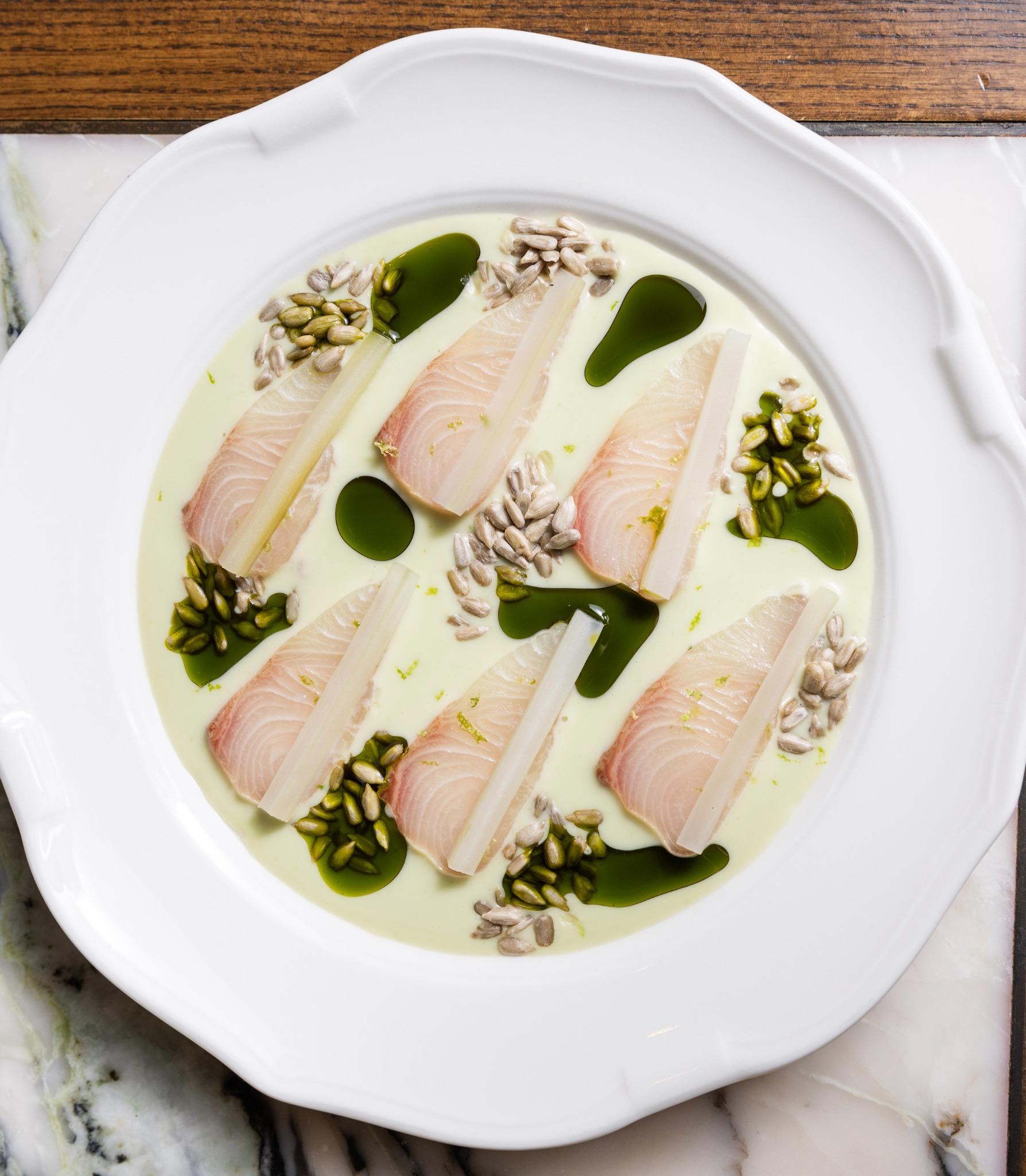 Hiramasa crudo with coconut leche de tigre, celery and sunflower seeds